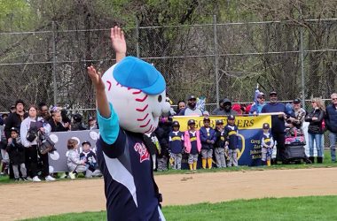 Flossmoor Baseball and Softball mascot Homerun Hank waves to the crowd during opening day ceremonies. (Eric Crump/H-F Chronicle)