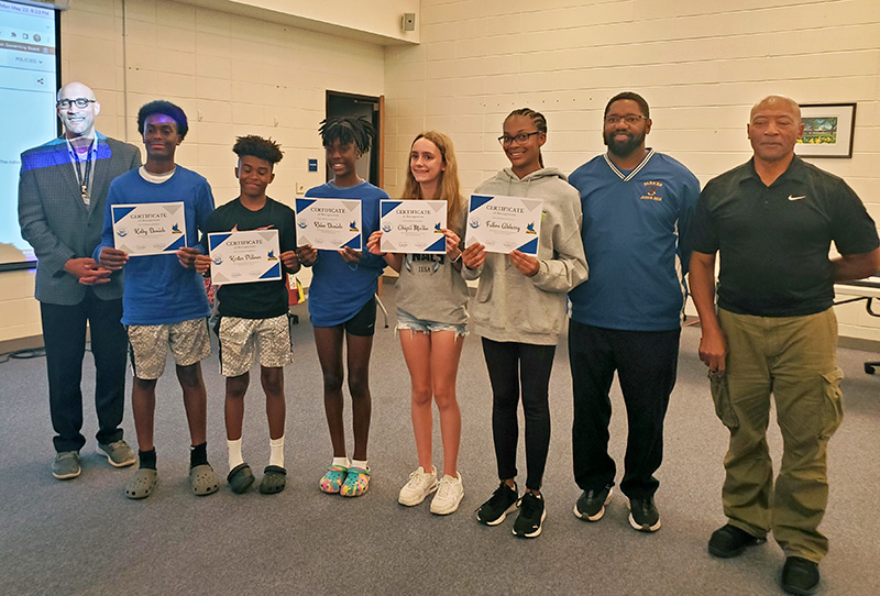 From left, Superintendent Dana Smith with Parker Junior High track team members Kolby Daniels, Karter Pillows, Khloe Daniels, Abigail Mullin, Fallon Alsberry and coaches Ronald Wright and Tom Morgan. (Chris Weber/H-F Chronicle)