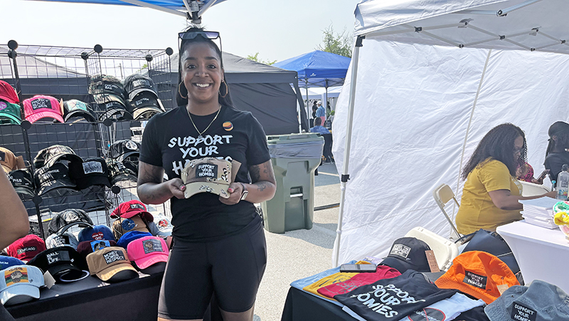 Artist Samantha Rose showing off one of her Support Your Homes hats. (Nick Ulanowski/H-F Chronicle)