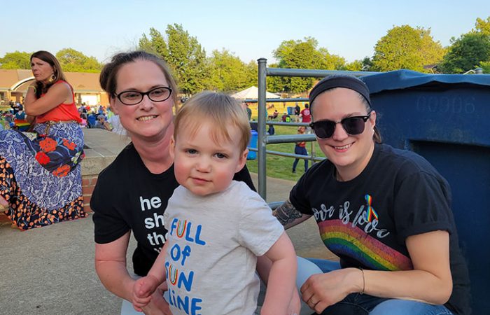 A family with positive messages. From left, Tara Kent, wearing a shirt saying "he, she, they, them, HUMAN," Lincoln Kent, 2, wearing a "FULL OF SUNSHINE" shirt, and Amy Kent, with a message of "Love is love." (Eric Crump/H-F Chronicle)