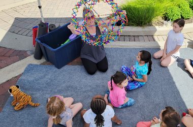 Yoga instructor Liz Smith guides young students through their moves during the opening day of Homewood's Farmers' Market in 2022. (Chronicle file photo)