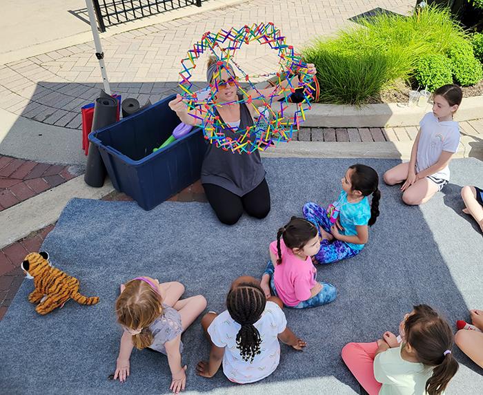 Yoga instructor Liz Smith guides young students through their moves during the opening day of Homewood's Farmers' Market in 2022. (Chronicle file photo)