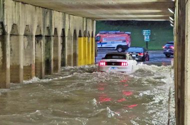 A car wades through the Dixie Highway viaduct in Homewood after a storm on July 5. Repairing the drainage system is on IDOT's to-do list, but it might be a few years in the future. (Eric Crump/H-F Chronicle)