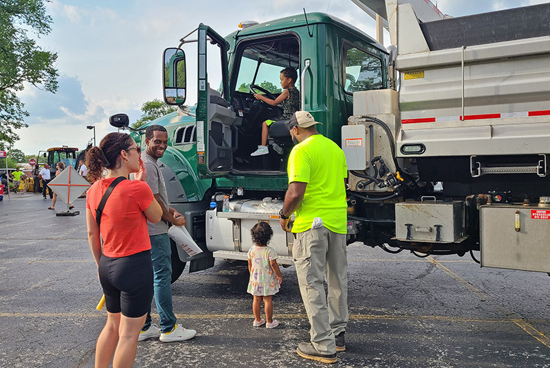 Families explore the Touch-a-Truck event, where they learn about the various vehicle and machinery used by staff throughout the village. (Jalyn Edwards/H-F Chronicle)