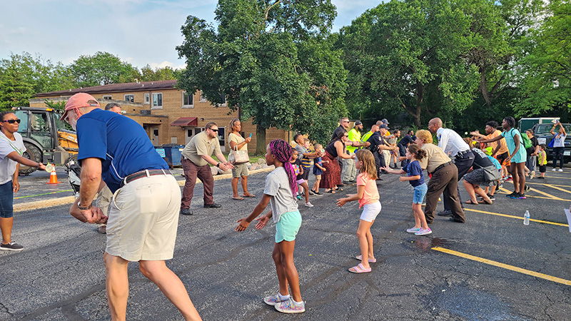 Village officials and residents pair up to participate in the water balloon toss. (Jalyn Edwards/H-F Chronicle)
