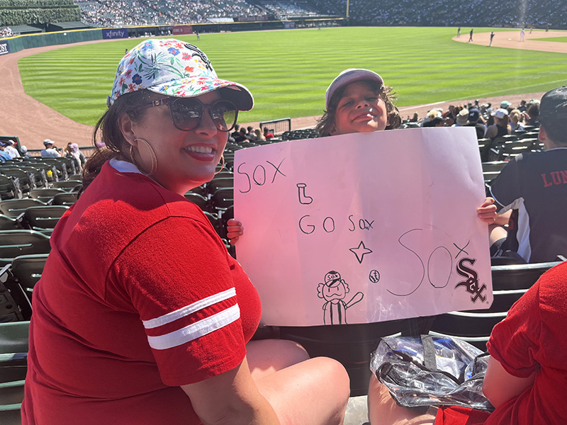 Gina LoGalbo, Flossmoor village clerk, with her son and his sign rooting for the Sox. (Nick Ulanowski/H-F Chronicle)