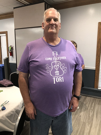 Rick Schram of ABC Supply shows off the T-shirt volunteers and supporters wore at the Make-A-Wish party for Tori Maszak. (Marilyn Thomas/H-F Chronicle)