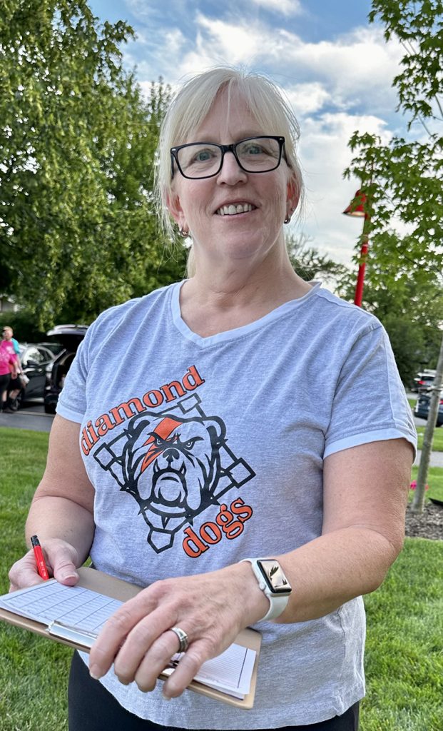 Kickball is a family affair for Brenda Feehery, who not only plays the game but keeps score and watched her eldest son pitch the July 13 game. (Karen Torme Olson/H-F Chronicle)