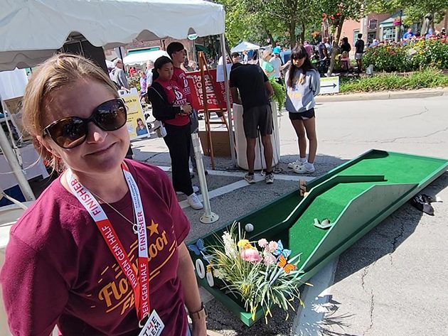 Flossmoor Mayor Michelle Nelson with a mini-golf game she built for the Foundation for the Preservation of Flossmoor History booth at Flossmoor Fest. (Eric Crump/H-F Chronicle)