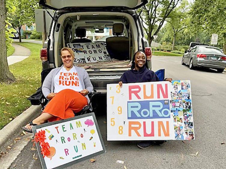 Rachel Engram-Sims, left, and Maryah Jones-Person are ready to support Maryah’s mother, Rochelle Jones-Person, when she runs past their vantage point. (Karen Torme Olson/H-F Chronicle)