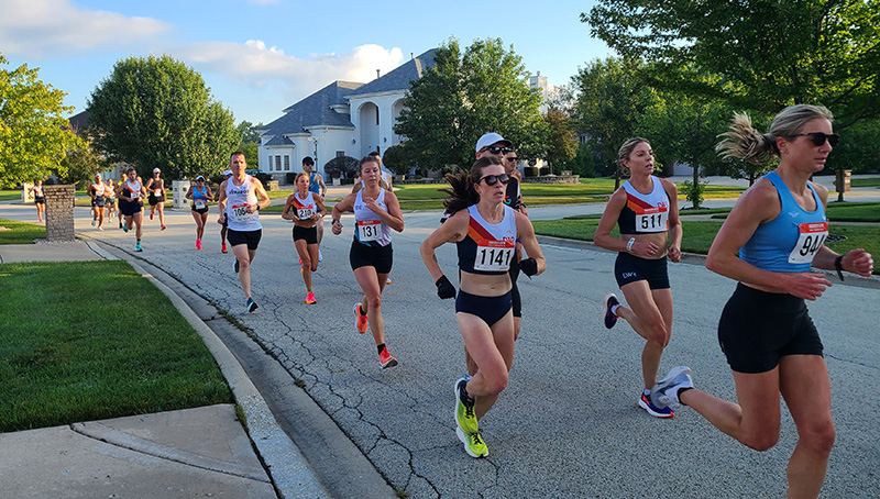 Runners making their way through mile marker 2 on Dunfries St. in the Ballantrae neighborhood. (Jalyn Edwards/H-F Chronicle)
