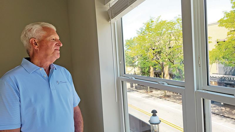 Developer Tim Flanagan takes in the view of Ridge Road from an apartment in The Hartford.