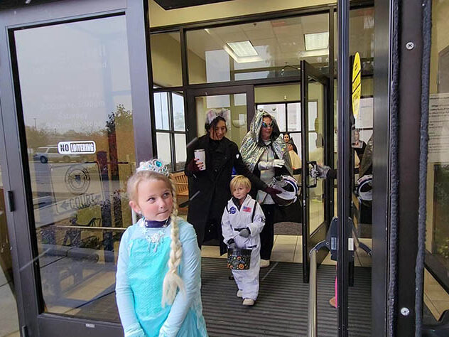 Trick or treaters leave Homewood village hall after visiting staffers Marla Youngblood and Antonia Steinmiller.