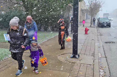 Trick or treaters head north on Dixie Highway through wind and snow.