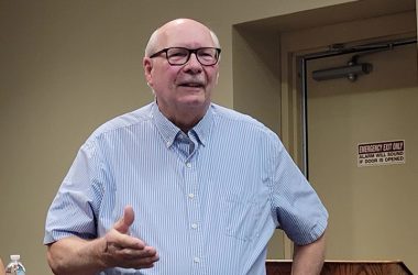 Kenneth Reusnow offers a few comments after being honored by the Homewood Board of Trustees for his more than 48 years of service to the village police department. (Eric Crump/H-F Chronicle)