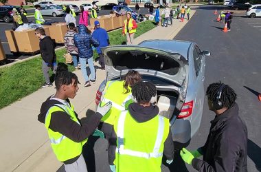 Volunteers unload items so drivers don't have to exit their vehicles to participate in Recyclepalooza. (Eric Crump/H-F Chronicle)