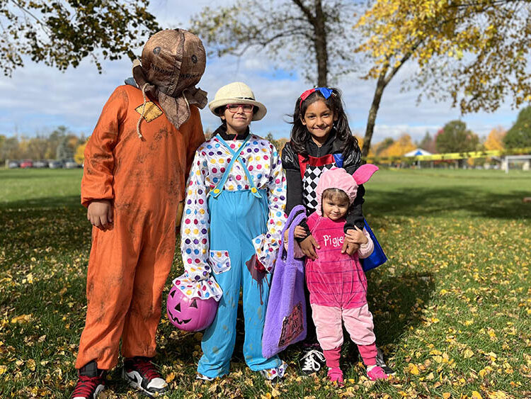 Brayan Favela, 12, left, Valerie Martinez, 8, Emely Favela, 9, and Vanessa Martinez, 2, trick or treat during the park district's Trick or Treat Trail. (Nuha Abdessalam/H-F Chronicle)