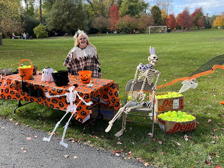 Brenda Feehery is ready for trick or treaters at her Homewood-Flossmoor Racquet & Fitneess Club table during Trick or Treat Trail on Oct. 28. (Nuha Abdessalam/H-F Chronicle)