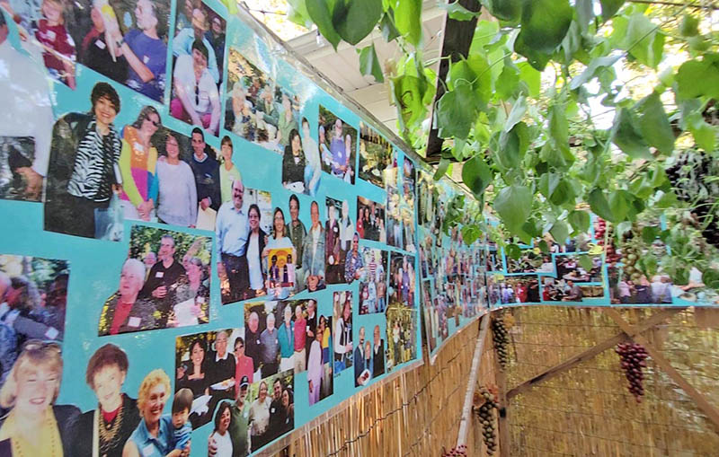 Photos from the first 25 of the Lippert’s annual Sukkot celebrations line the sukkah at this year’s gathering. (Eric Crump photos/H-F Chronicle)