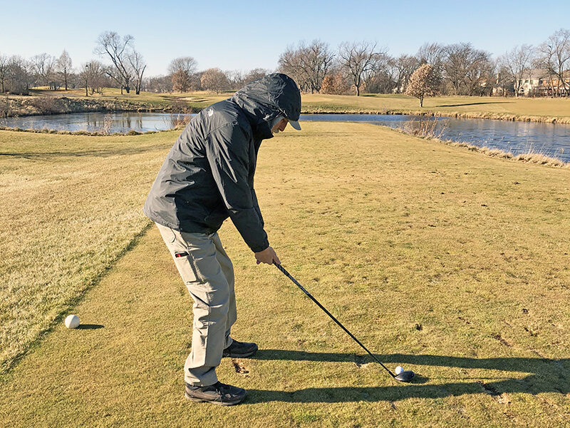 Mike Zarifis gets ready for his shot from the tee and across the pond at Coyote Run Golf Course on Thursday, Dec. 14. (Marilyn Thomas photos/H-F Chronicle)