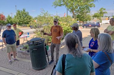 Tristan Shaw, center, uses a container-grown tree to explain how root systems develop during a Green Thumb Saturdays presentation on July 12. (Nuha Abdessalam/H-F Chronicle)