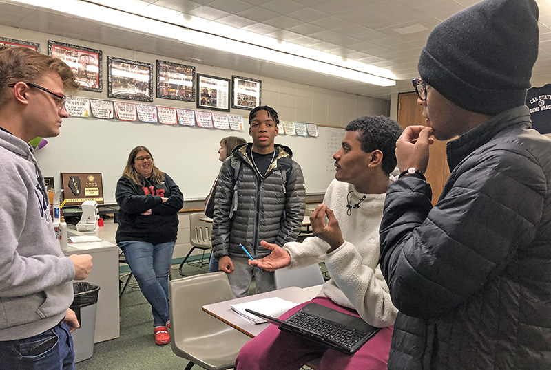 Tarendran Heyward, seated, makes a point in discussion with fellow H-F Debate Club members, from left, Kevin Gibek, Harold Owens, and Undra Pillows. (Marilyn Thomas photos/H-F Chronicle)