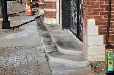 Concrete steps at the west entrance to the Hibbing Building are the focus of a dispute between village officials and the owner of the building. (Eric Crump/H-F Chronicle)