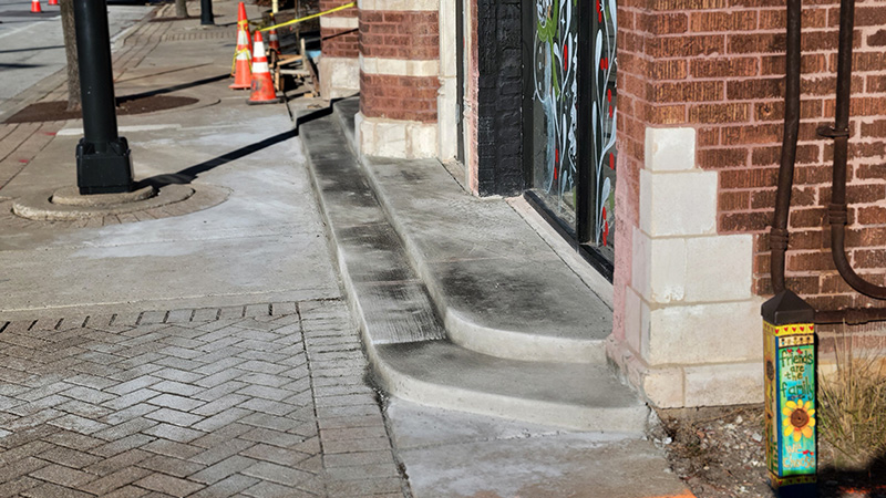 Concrete steps at the west entrance to the Hibbing Building are the focus of a dispute between village officials and the owner of the building. (Eric Crump/H-F Chronicle)