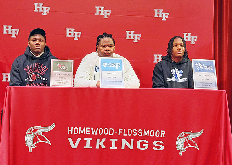 Homewood-Flossmoor's three football college signees pose at Wednesday's event. (David P. Funk/H-F Chronicle)