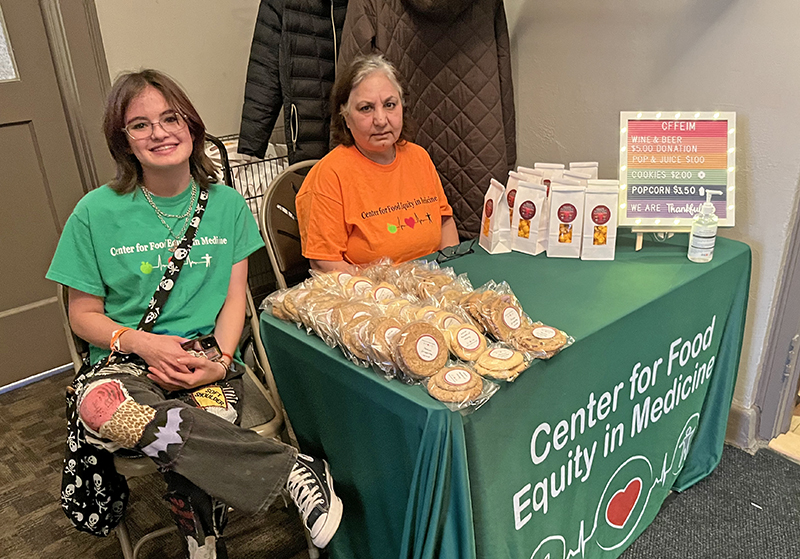 Center for Food Equity entrance volunteers, from left, Noelle Kelly and Yazdy help Soup for Soul attendees at the entrance to the fundraising event at FCC Community House. (Nick Ulanowski/H-F Chronicle)