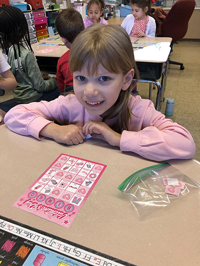 Romy Matushek enjoyed a game of bingo with her first grade class at Willow School. (Marilyn Thomas/H-F Chronicle)