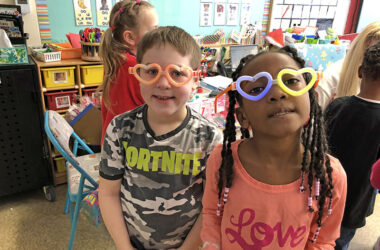 Hiram Cheffer, left, and Elianna Kline, first graders at Willow School, show off their 'love' glasses as the class celebrated Valentine's Day Wednesday. (Marilyn Thomas/H-F Chronicle)