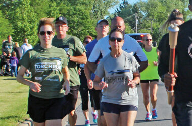 Homewood Police Chief Denise McGrath, center, runs in the Torch Run to raise funds for Special Olympics. She is a long-time runner who finally got to run in Flossmoor's Hidden Gem Half Marathon this year. (Chronicle file photo)