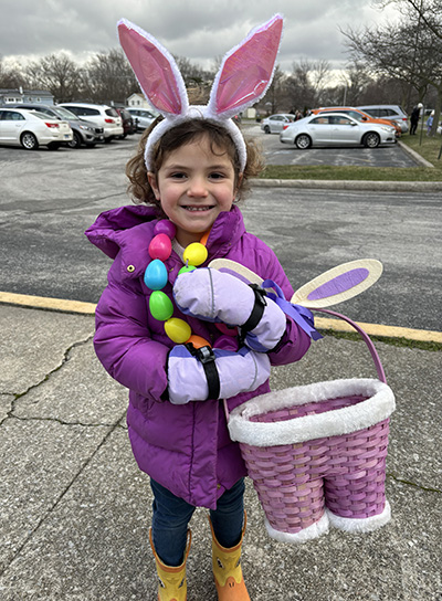 Violet Airey, 4, was decked out in beads and bunny ears at the H-F Park District Easter egg hunt. (Marilyn Thomas/H-F Chronicle)