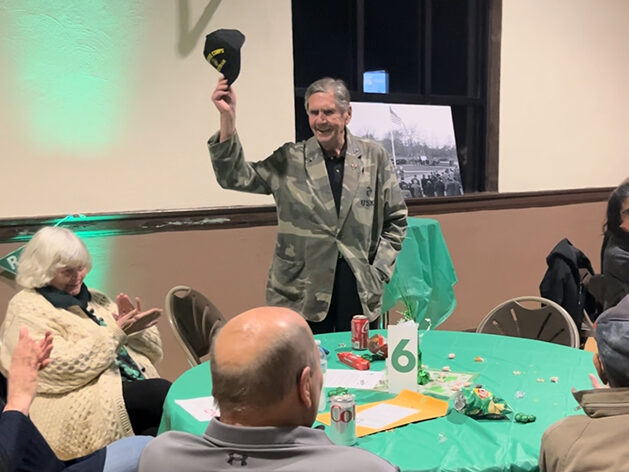 John Beele, a Flossmoor resident, Marine Corp veteran and commander of the Wally Burns VFW Post in Homewood, sings the Marine Corp Hymn at the Flossmoor Veterans Memorial trivia night. (Nick Ulanowski/H-F Chronicle)