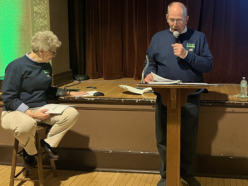 Flossmoor Veterans Memorial president Paul Braun reads trivia questions at the organization's annual fundraiser Friday, March 15. Secretary-treasurer Kris Condon sits nearby. (Nick Ulanowski/H-F Chronicle)
