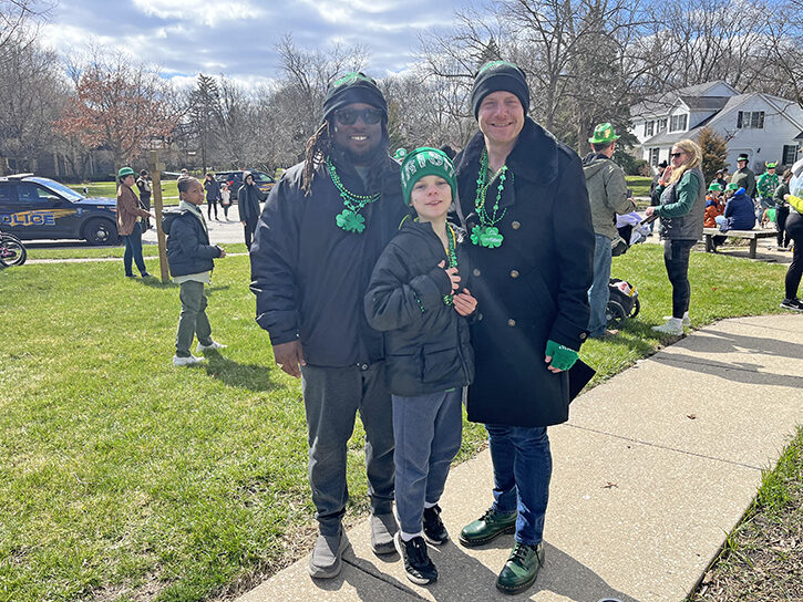 Quadree Holmes, left, and Troy Holmes join the parade with their son Nigel. They said they chose Flossmoor because it looked like a community that celebrates diversity. (Nick Ulanowski/H-F Chronicle)