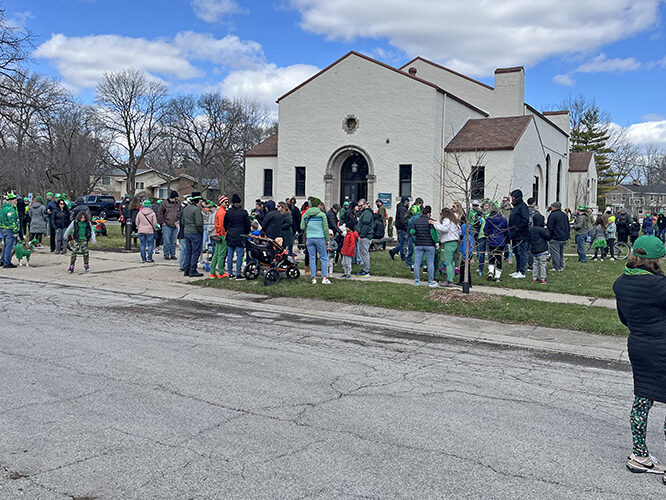 The crowd gathers in front of the Flossmoor Community House for the annual St. Patrick's Day Parade. (Nick Ulanowski/H-F Chronicle)
