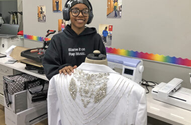 Kevonna Henderson shows off a jacket she was asked to create with lots of bling for a birthday celebration. Henderson, a senior, has taken every Clothing Construction class at Homewood-Flossmoor High School and appreciates the updates to the classroom. (Marilyn Thomas/H-F Chronicle)