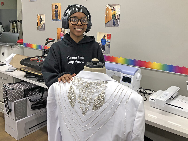Kevonna Henderson shows off a jacket she was asked to create with lots of bling for a birthday celebration. Henderson, a senior, has taken every Clothing Construction class at Homewood-Flossmoor High School and appreciates the updates to the classroom. (Marilyn Thomas/H-F Chronicle)