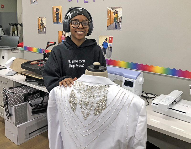 Kevonna Henderson shows off a jacket she was asked to create with lots of bling for a birthday celebration. Henderson, a senior, has taken every Clothing Construction class at Homewood-Flossmoor High School and appreciates the updates to the classroom. (Marilyn Thomas/H-F Chronicle)