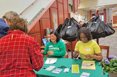 George and Adrienne Olsen, left, check in for the new resident reception at Flossmoor Public Library on April 13. Community Relations Commission member Molly Deugaw and commission Chair Phillipa Leon-Thompson greet the Olsens. (Eric Crump/H-F Chronicle)