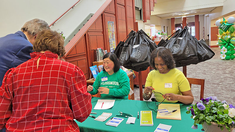 George and Adrienne Olsen, left, check in for the new resident reception at Flossmoor Public Library on April 13. Community Relations Commission member Molly Deugaw and commission Chair Phillipa Leon-Thompson greet the Olsens. (Eric Crump/H-F Chronicle)