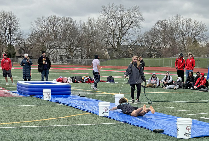 Ryan Castady slides to the dunk pool at the Homewood-Flossmoor High School Polar Plunge benefit for Special Olympics. (Marilyn Thomas/H-F Chronicle)
