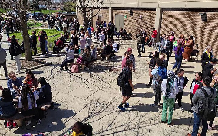 The Scholars Garden at Prairie State College fills with people as the solar eclipse begins on April 8. (Eric Crump/H-F Chronicle)