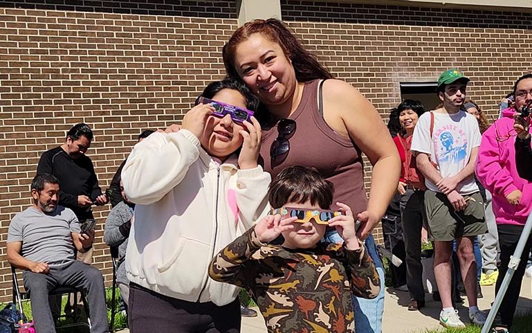 Citlally, Guadalupe and Abraham Avina of Chicago Heights are ready to watch the eclipse from the Scholars Garden at Prairie State College. (Eric Crump/H-F Chronicle)