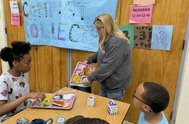Parent volunteer Patty Welsh collects lunch cast-offs for the composting project at Churchill School. (Marilyn Thomas/H-F Chronicle)