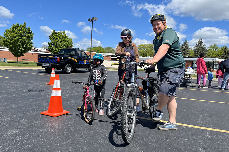 From left, Ruby, Mary and Bret Schepler on course for the Flossmoor Bike Rodeo. (Nuha Abdessalam/H-F Chronicle)