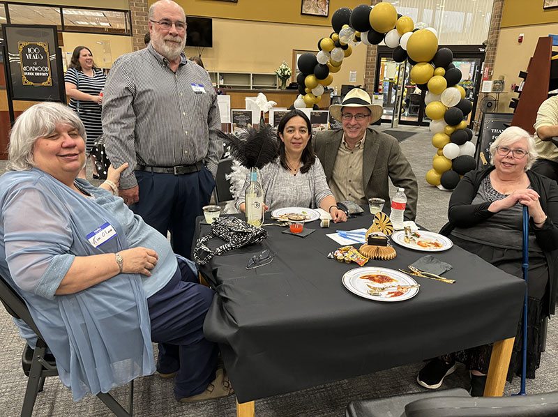 Celebrants at the Homewood Public Library's 100th anniversary celebration are, from left, Kim O'Lone, Jim Joyce, Sharon Bouchie, former library board member George Bouchie and librarian Sharon Lade. (Marilyn Thomas/H-F Chronicle)