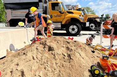 Ethan Bauer and Hope Peele play on a sand hill at the Homewood Public Works Department open house on May 18, 2024. (Nuha Abdessalam/H-F Chronicle) 